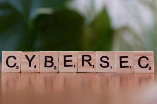 Wooden letter tiles spelling CYBERSEC, representing cybersecurity in software testing and AI security.